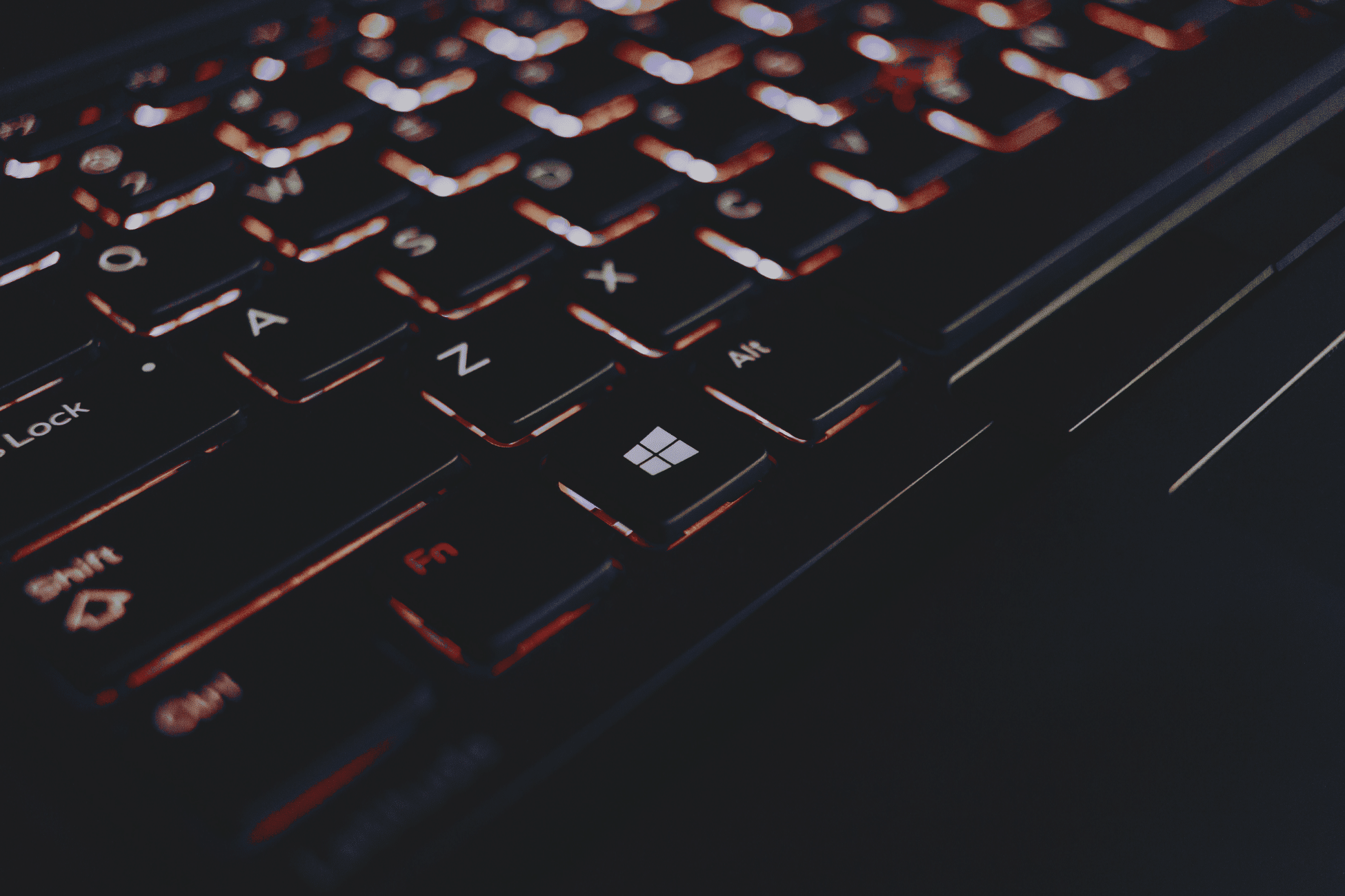 A black window's keyboard with orange backlighting. » admin by request » admin by request