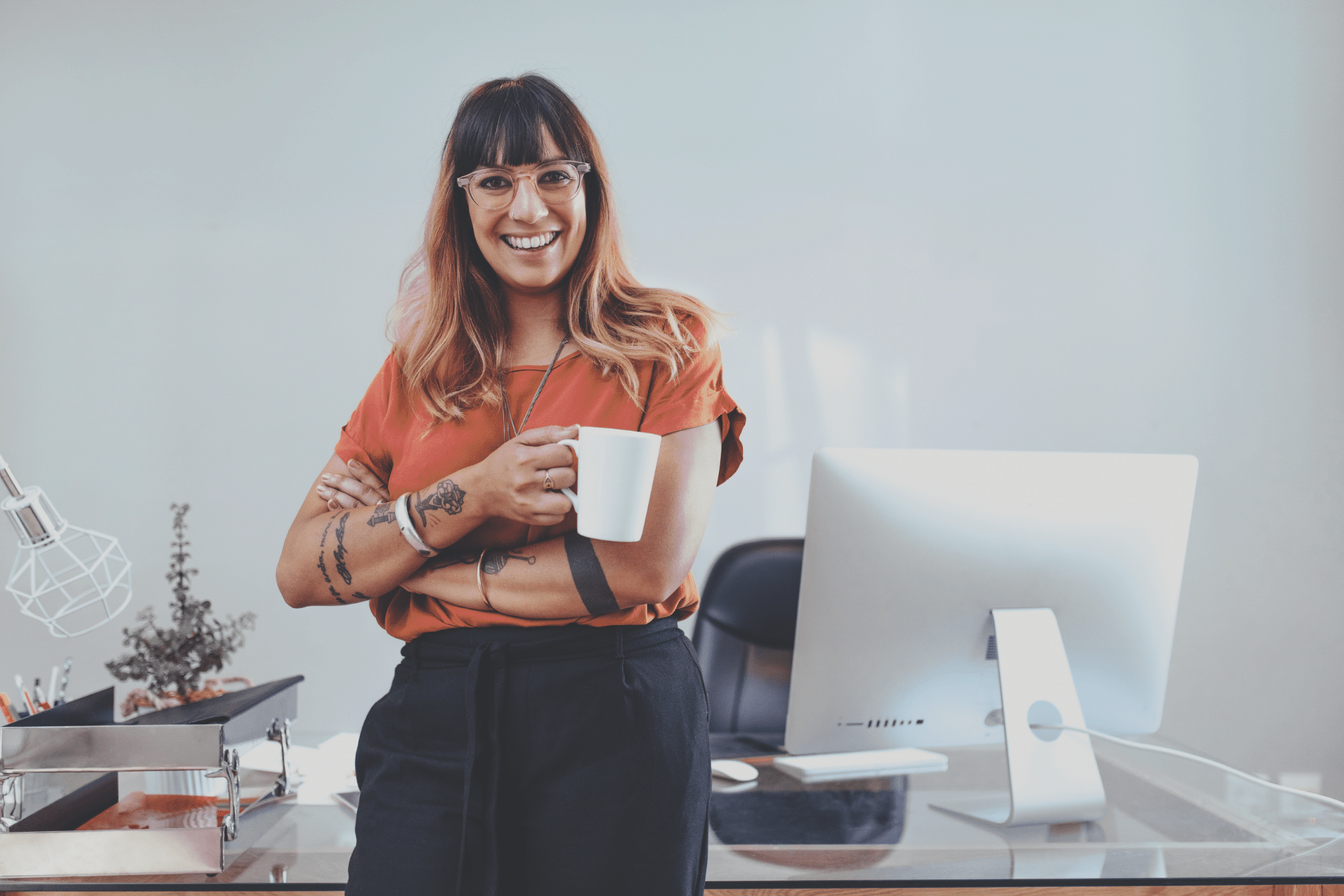 Meet global compliance requirements. Smiling woman holding a cup of coffee, leaning against her workdesk. » admin by request » admin by request