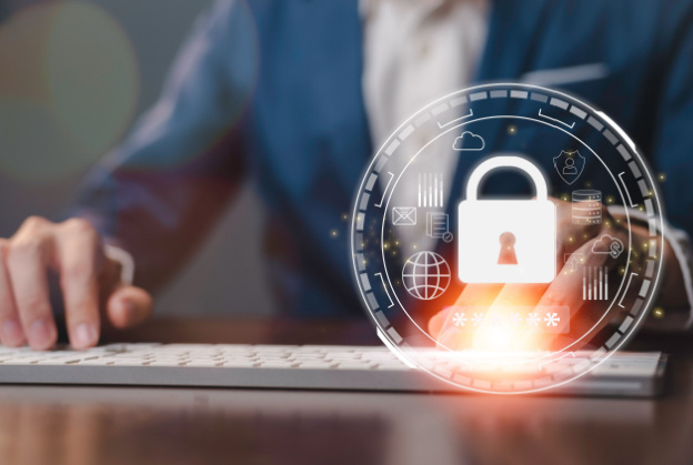 Business professional using a keyboard with a digital lock hologram symbolizing data security and online protection.