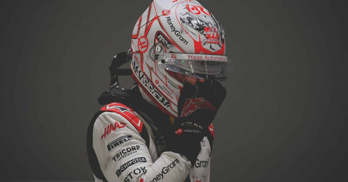 Kevin Magnussen at the Singapore Grand Prix adjusting his helmet 2023